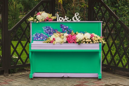 Royal wedding ceremony in spring with piano decorated by flowersの写真素材