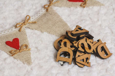 Letters and rustic flag with red heart on white textileの写真素材