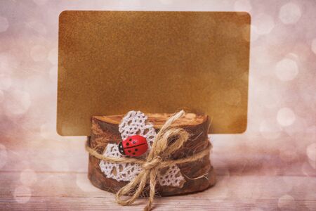 Rustic background with wooden card holder and gold place for textの写真素材