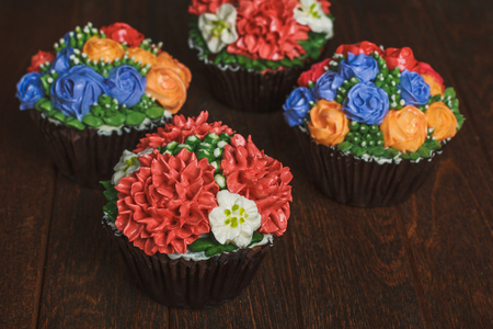 Creamy muffins with red flowersの写真素材
