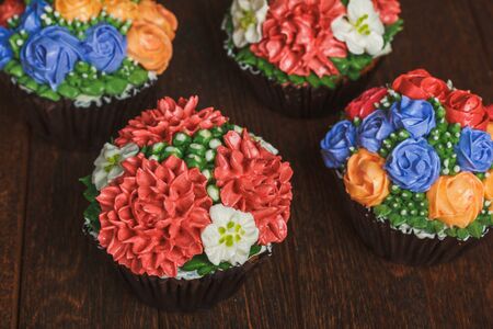 Creamy muffins with red flowersの写真素材