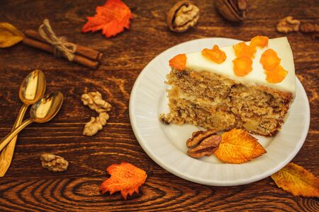 Carrot cake with walnuts on brown wooden backgroundの写真素材