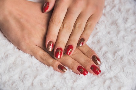 Festive nail art with stars in red and gold colorsの写真素材