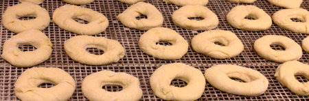 Multiple donuts being prepared in a pastry ship