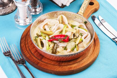 Mediterranean noodle soup with colmar rings, onions, cucumbers and hot peppersの写真素材