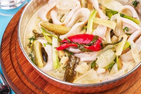 Mediterranean noodle soup with colmar rings, onions, cucumbers and hot peppersの写真素材