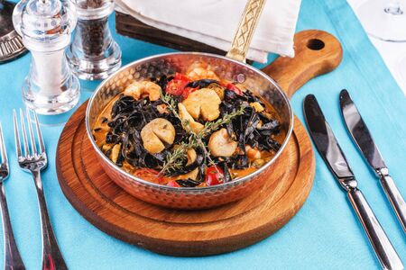 Mediterranean black pasta with scallop, prawn, calamari and rosemaryの写真素材