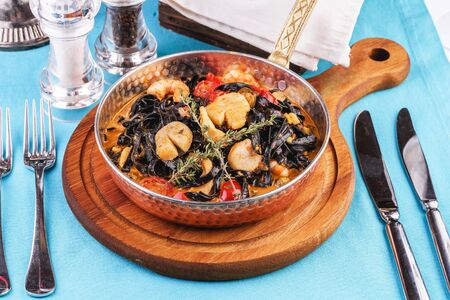 Mediterranean black pasta with scallop, prawn, calamari and rosemaryの写真素材