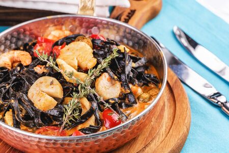 Mediterranean black pasta with scallop, prawn, calamari and rosemaryの写真素材