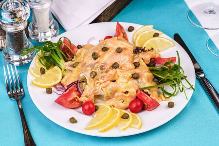 Roast with cream sauce, with Colmar, shrimps, tomatoes, decorated with nuts and onions according to a Mediterranean recipeの写真素材