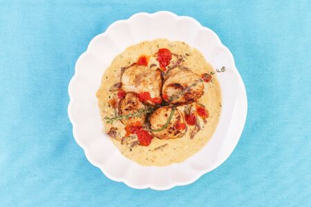 Pan-seared scallops with creamy brothの写真素材