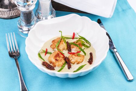 Pan-seared scallops with creamy brothの写真素材
