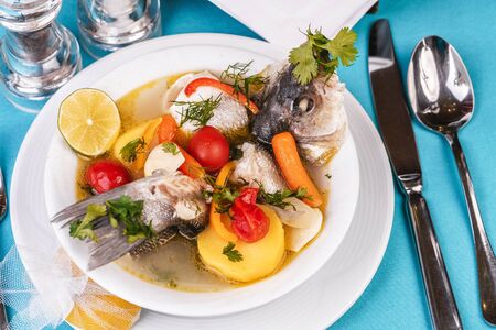 Mediterranean fish soup with vegetables and limeの写真素材
