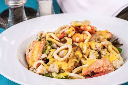 Mediterranean stew with seafood, chicken and cheese.の写真素材