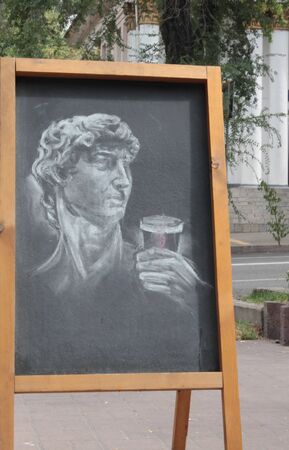Kazakhstan, Almaty, October 14, 2019. Street art, classic chalk drawing on the blackboard, David Michelangelo with about a glass of coffe.のeditorial素材