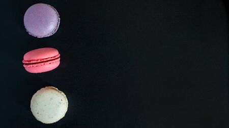 Macaroons cookies on a dark canvas background. view from above. copy spaceの写真素材