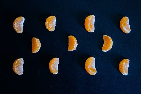 Dark textured christmas background with tangerine slices. Background for banner, copyspace. view from above.の写真素材