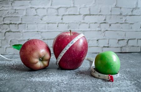red and green apple for weight loss while dieting, centimeter measuring tapeの写真素材