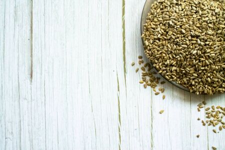 sunflower seeds on a plate on a wooden background close-up. textureの写真素材