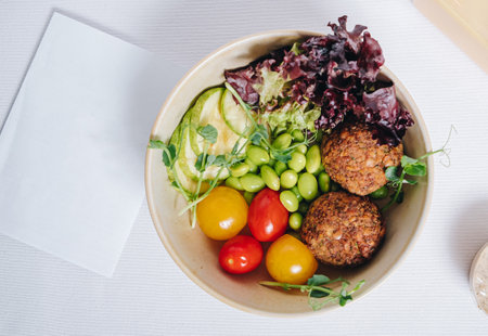 bowl in Chinese style.meatballs with beans, herbs, cherry tomatoes and sauce in a bowlの写真素材