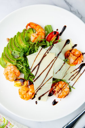 shrimp with avocado slices and arugula with teriyaki sauce top viewの写真素材