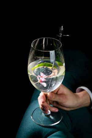 side view of transparent cocktail with ice on a dark backgroundの写真素材