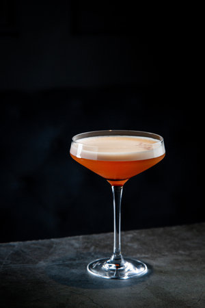 side view of tropical cocktail with foam on top in martini glassの写真素材