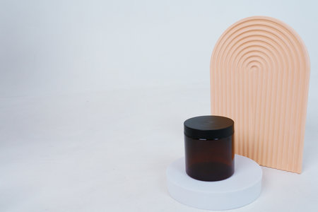 Composition with geometric shapes.body care. jar of cream on a light gray background. Advertising conceptの写真素材