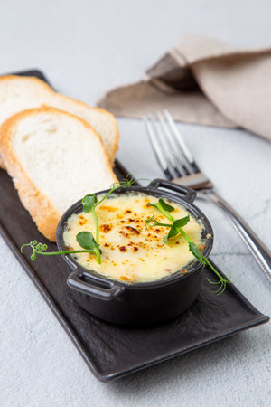 Julienne in a mug with pieces of bread side viewの写真素材