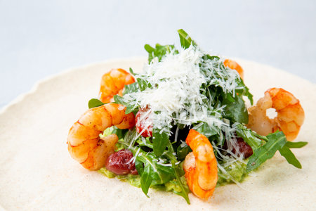 beautifully served shrimp with arugula and grated cheese, side viewの写真素材