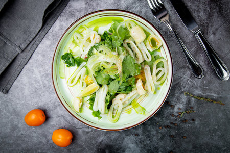 salad with arugula, parsley, lime and squid rings, side viewの写真素材
