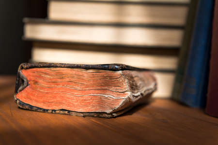 Detail photograph of an old book in which the texture of the leaves is appreciated with a stack of...