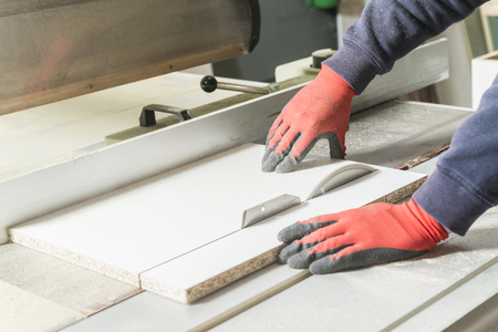 Worker man concept. Male carpenter working in his carpentry workshop.の写真素材