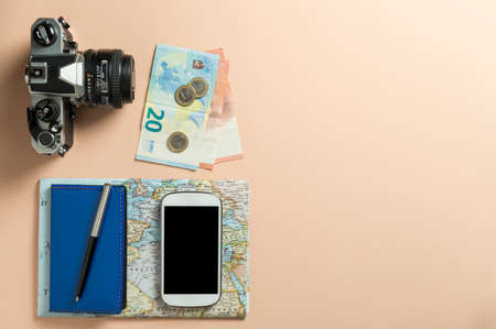 Conceptual still life with various objects related to travel on pink background.の写真素材