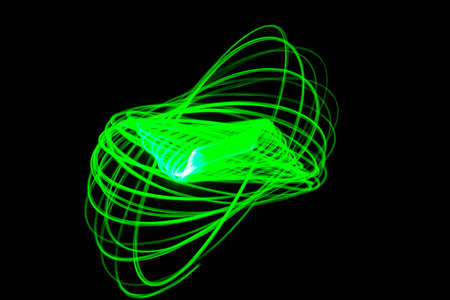 Pattern of green lines on a black background painted with the light of a lantern.の写真素材