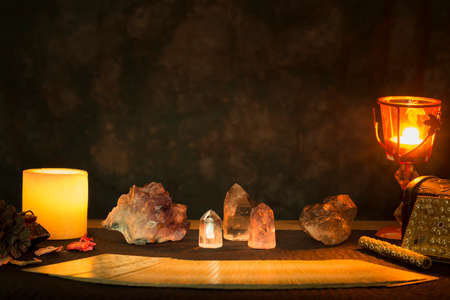 Tarot cards and other objects on a black card table for a fortune telling session. Concept of a...