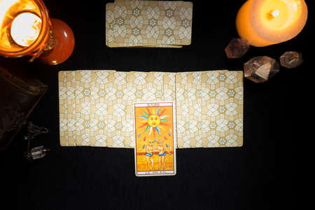 Tarot sun card on a group of cards face down. Concept of a divination session with tarot cards. View from above.の写真素材