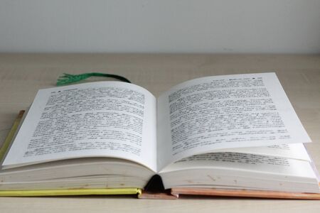 A story book written in tamil language is in open position ready to be read by someone