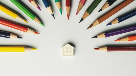 small house and crayons on white background - vintage style