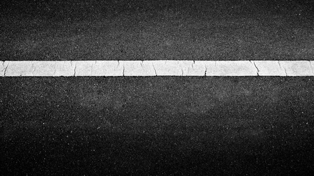 white paint line on black asphalt. space transportation backgroundの写真素材