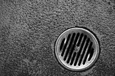 dirty lid of drain pipe in bathroomの写真素材