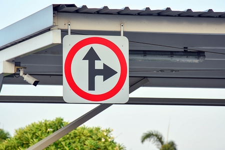 Turn right and go straight traffic sign in the park
