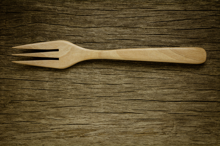 wood fork on old wooden desk. - vintage style.の写真素材