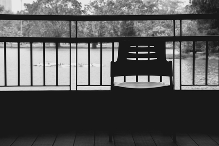 alone plastic chair in the park. Feeling lonely - monochromeの写真素材