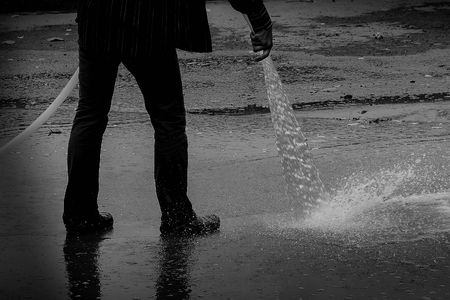 firefighters spray water to the floor - monochromeの写真素材