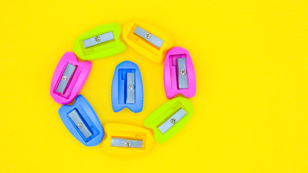 colorful of plastic pencil sharpener on yellow background