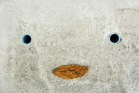 concrete drain hose looks like a smiling manの写真素材