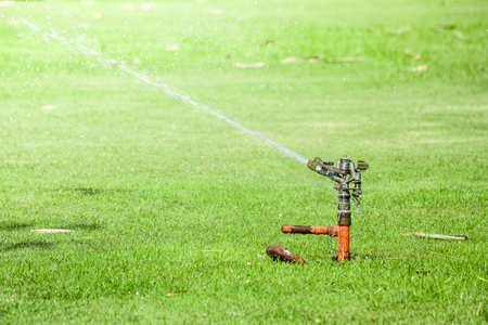 Lawn water sprinkler spraying a waterの写真素材