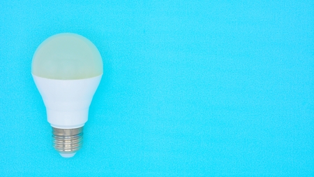light bulb on blue paper backgroundの写真素材