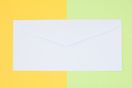 white envelope mail on yellow and green background